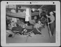 Newly-arrived WACs do a bit of tidying up in their barracks at a camp somewhere in New Guinea. T/4 Minnie Holbenof Folgelsville, Pennsylvania, takes it easy on her cot while T/4 Gillie Tanksley of Bokoshe, Oklahoma, and Pfc. Thelma Boyer of St. Louis - Page 1