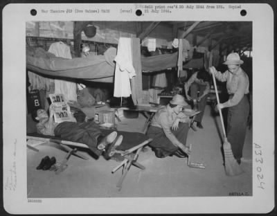 Consolidated > Newly-arrived WACs do a bit of tidying up in their barracks at a camp somewhere in New Guinea. T/4 Minnie Holbenof Folgelsville, Pennsylvania, takes it easy on her cot while T/4 Gillie Tanksley of Bokoshe, Oklahoma, and Pfc. Thelma Boyer of St. Louis