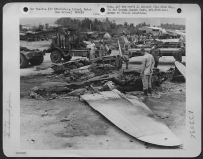 Thumbnail for Consolidated > Due to a Japanese raid on Middleburg Island, off the coast of Dutch New Guinea, the fighter groups lost a few planes from direct hits and fires were started in the gas tanks of fighters as a result from shrapnel. Shown here is one of the demolished