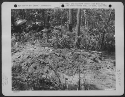 Consolidated > Graves of glider troops who were killed when their glider crashed into the trees at Chowringhee in Burma. Glider wreckage can be seen in the background. 1st Air Commando Force.