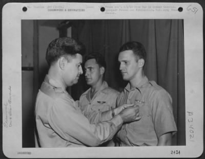 Consolidated > Major General Curtis E. LeMay (left) pins the Air Medal on two crew members of his ship at a 20th Bomber Command base somewhere in India. At right is Capt. Renato Simoni of San Jose, Calif., co-pilot on the plane, and T/Sgt. Jack Holland of Wareshols