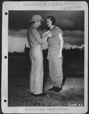 Consolidated > In the midst of a tropical moonsoon cloudburst, Captain Ira M. Sussky of Little Rock, Arkansas, 25th Fighter Squadron, 51st Fighter Group pilot, receives the Distinguished Service Cross from Major General Clayton L. Bissell, Commanding General of the
