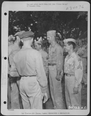 Thumbnail for Consolidated > Col. C.F. Necrason (back to camera) and Maj. W. Werner congratulating S/Sgt. Uhle Whitsel, Houston, Texas and Sgt. Anthony Ablaza, New York City, New York on receiving the Air Medal. India.