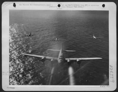 Consolidated > Photographed over the tail guns of a leading Fortress, these B-17s of the U.S. Army Air Forces are on their way to bomb military targets in southern France. Below them is the blue Mediterranean.