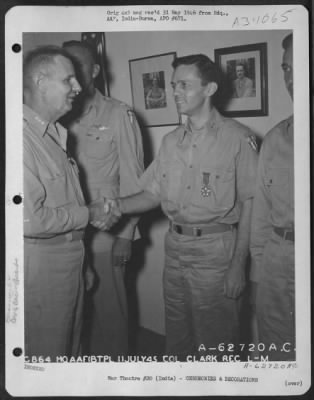 Consolidated > Lt. General George E. Stratemeyer congratulates Col. Clark after presenting him with the Legion of Merit at an airbase in India on 11 July 1945.