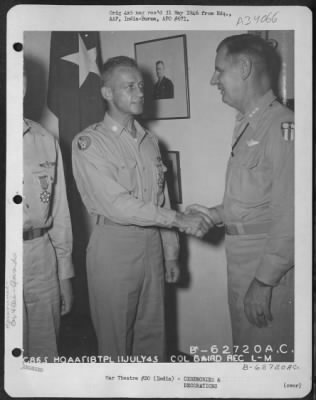 Consolidated > Lt. General George E. Stratemeyer congratulates Lt. Col. Baird after presenting him with the Legion of Merit at an airbase in India on 11 July 1945.