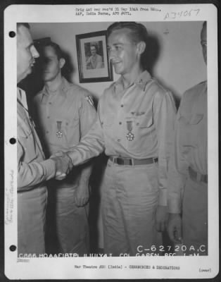 Consolidated > Lt. General George E. Stratemeyer congratulates Colonel Gapen after presenting him with the Legion of Merit at an airbase in India on 11 July 1945.