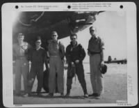 Crew of the Martin B-26 "Fiddle, Benito While Rome Burns!" of the 34th Bomb Squadron, 17th Bomb Group pose beside their plane at an airfield somewhere in the Mediterranean Area. - Page 1