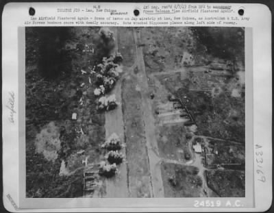 Consolidated > Lae Airfield Plastered Again-Scene of havoc on Jap airstrip at Lae, New Guinea, as Australian & U.S. Army Air Forces bombers score with deadly accuracy. Note wrecked Nipponese planes along left side of runway.