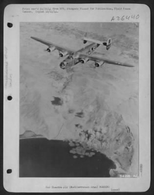 Consolidated > Over the smoke covered harbor installations at Scaramanga flies this Consolidated B-24 Liberator of the 15th AF on 24 Sept 44 as its bombs burst on the few remaining submarines in the Mediterranean and on communication facilities. The heavy bombers