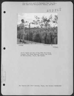 Consolidated > Joe E. Brown And Men Of The 38Th Bomb Group Singing 'God Bless America' During His Visit At Port Moresby, Papua, New Guinea.