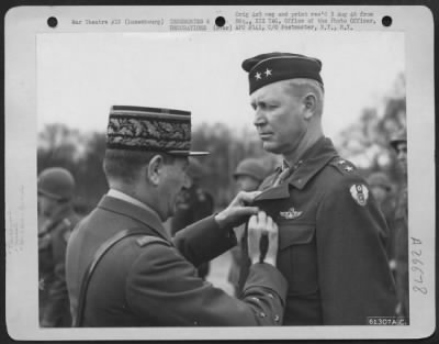 Consolidated > Major General O. P. Weyland, Commanding General Of The Xix Tactical Air Command Is Presented With The Criox De Guerre With Palms And The Legion Of Honor By General Louis Koelz, Acting For General Charles De Gaulle.  The Presentation Ceremony Took Place In