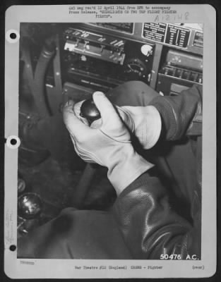 Fighter > ENGLAND-This peaceful scene often spells death for a Nazi flyer. This is the grip used by Capt. Duane W. Beeson, USAF fighter ace whose hands are seen here, when firing at Nazi aircraft. He uses both hands for holding the stick and firing the button