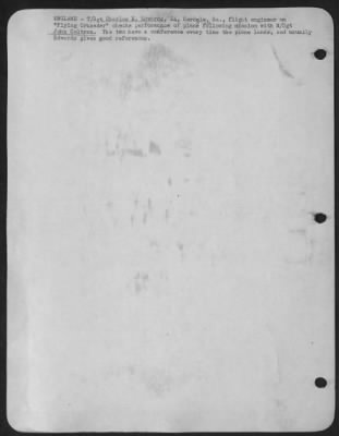 Ground > ENGLAND-T/Sgt Charles E. Edwards, 24, Cordele, Ga., flight engineer on "Flying Crusader" checks perofrmance of plane ofllowing mission with M/Sgt John Coltran. The two have a conference every time the plane lands, and usually Edwards gives good