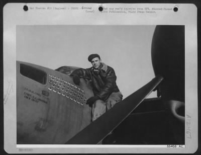 Thumbnail for Ground > That's T/Sgt. Sherman L. Housman of Paducah, Kentucky, seated on the wing of the twin-engined 8th Air force Mosquito. The figures at which he is pointing sigify that this aircraft, of which he is crew chief, has completed 50 missions over Germany