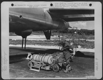 Thumbnail for Consolidated > In Preparation For A Bombing Mission Over Tokyo, Japan, An Armorer Moves Bomb Dolly Holding A 500 Lb. Incendiary Bomb Under The Fuselage Of A Boeing B-29 "Superfortress".  Isely Field, Saipan, Marianas Islands, November 29, 1944.