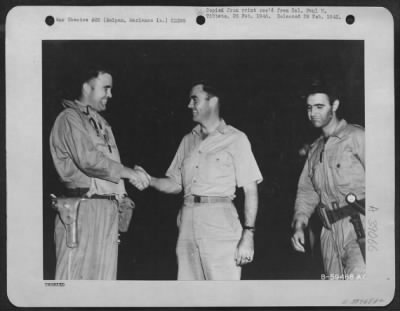 Consolidated > Marianas Islands.  Major Charles W. Sweeney, Pilot Of The B-29 'Bockscar' Which Dropped The Atomic Bomb On Nagasaki, Japan, 9 August 1945, Is Shown Before His Mission Shaking Hands With Colonel Paul W. Tibbets, Pilot Of The B-29 'Enola Gay' Which Atom-Bom