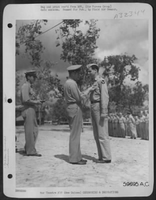 Thumbnail for Consolidated > New Guinea, 17 September 1943, Captain John R. Wilson, 812 West 8th St., Pittsburg, Kansas, being presented with the Silver Star for Gallantry in Action and the Distinguished Flying Cross by Brig. General Roger Ramey. Capt. Wilson also holds the Air