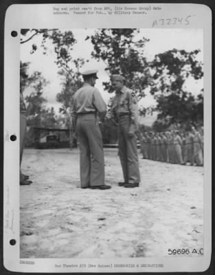 Thumbnail for Consolidated > New Guinea, 17 September 1943, S/Sgt. Edwin A. Williams, Box 136, Chillicothe, Texas being decorated with the Distinguished Flying Cross by Brig. General Roger Ramey. S/Sgt. Williams flies as aerial gunner on a Consolidated B-24 Liberator bomber with