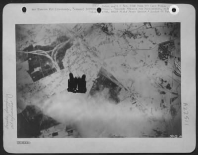 Consolidated > BOMBS AWAY--Early in the attack on the German oil plant at Sterkrade, Germany, January 22, 1945 by U.S. Eighth Air Force heavies, bombs from the attackers head down in a compact cluster.