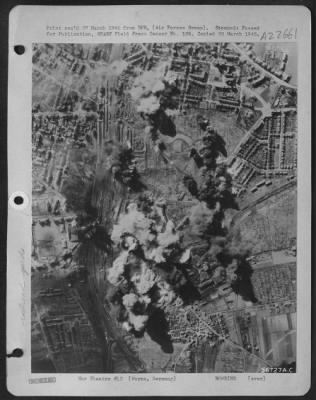 Consolidated > Bomb strikes from part of a force of Martin B-26 Marauders which attacked the Worms Marshalling yard in Germany mushroom into smoke columns where they cut rail lines and laid waste to cars, sidings, and warehouses.