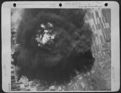 Consolidated > GAS PLANTS AT ZIETZ BOMBED-Dense smoke with a flaming center seen rising from raging inferno of gas plant at Zietz, Germany, following fierce attack by heavy bombers of U.S. 8th RAF. Direct hits were made on three quarters of the north and containing