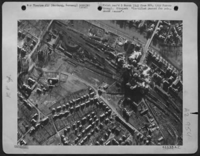 Consolidated > Bomb Bursts From Martin B-26 Marauders Cut Main Rail Lines, Destroyed Freight Cars And Hit Half The Length Of The Loading Platform And Main Station Building At The Railroad Yard In Marburg, Germany, Shown Here Under Attack Feb. 22 1945.  A Few Minutes Aft