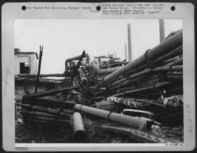 Consolidated > The Framework Of Pipes Which Fed The German War Machine Was Greatly Dislocated During The Air Attacks By The Us 8Th Af And The Raf On The Leuna Oil Works At Merseburg, Germany.  The Small Building At Left Pock-Marked By Effects Of The Blast.