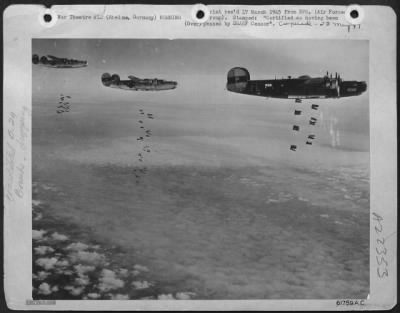 Consolidated > Bombs Drop From The Open Bomb Bays Of Three Consolidated B-24 Liberators Of The Us 8Th Af As They Unload Over The Marshalling Yards At Rheine, Germany, 9 March 1945.  Liberators Of The 2Nd Air Division, Part Of A Force Of 1,000 Boeing B-17 Flying Fortress