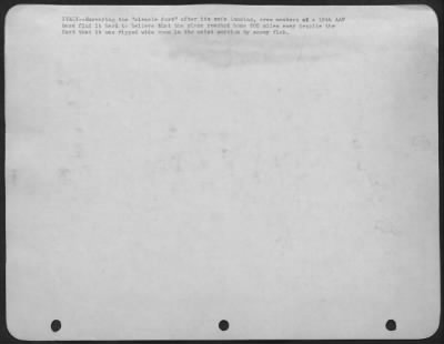 Consolidated > ITALY--Surveying the "Miracle fort" after its safe landing, crew members of a 15th AAF base find it hard to believe that the plane reached home 600 miles away despite the fact that it was ripped wide open in the waist section by enemy flak.