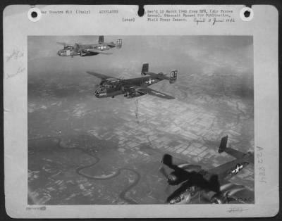Consolidated > Its bombardier dead in the wreckage of its flak-riddled nose section, the center plane keeps its place in a 12th AF North American B-25 Mitchell bomber formation on the return flight from a bombing attack against a bridge in northern Italy.