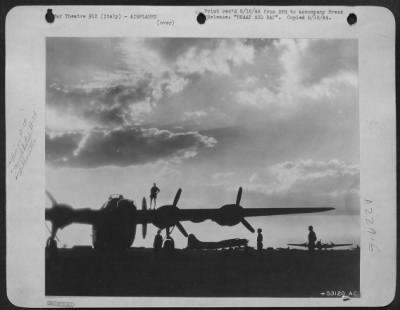 Thumbnail for Consolidated > While two Boeing B-17 Flying Forts of the 15th USAAF rest in their dispersal area after a long mission, the RAF ground crew of an American built Consolidated B-24 Liberator, preflight their aircraft for its night missions. Close cooperation between