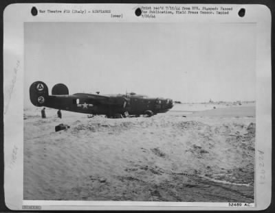 Consolidated > Bogged down in the shifting sands of the Adriatic Sea in eastern Italy, this Consolidated B-24 Liberators presents a sad picture, after it was forced to crash-land because of damage received by enemy fire while on a mission over northern Italy. An 11