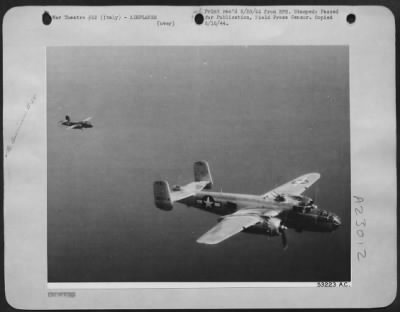 Thumbnail for Consolidated > While on a mission to attack axis communications in Italy, the right rudder of the North American B-25 Mitchell bomber of the 1st Tactical Air Force (shown in the extreme left of this photograph) was shot off by German anti-aircraft fire. Unable to