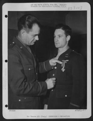 Consolidated > Capt. Thomas W. Ferebee of Mocksville, N.C., receives the Distinguished Flying Cross from Brig. General Joseph A. Atkinson. Italy.