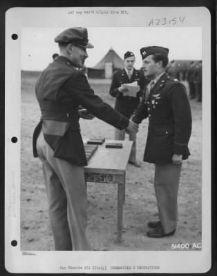 Thumbnail for Consolidated > With the Silver Star pinned on his tunic, Capt. John S. Litchfield, Aurora, N.C., is shown being congratulated by Col. Charles W. Lawrence, Commanding Officer of an AAF Wing, who made the presentation to the P-38 Lightning squadron commander and