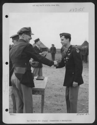 Thumbnail for Consolidated > With the Silver Star pinned on his tunic, 1st Lt. Douglas A. Neilson, 4331 Minehaha Ave., Minneapolis, Minn., is shown being congratulated by Col. Charles W. Lawrence, Commanding Officer of an AAF Wing, who made the presentation to the P-38 Lightning