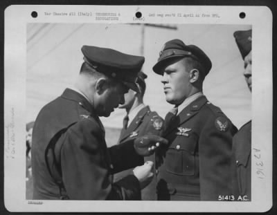 Thumbnail for Consolidated > Wing Commanding Officer pins the Distinguished Flying Cross on 1st Lt. Robert L. Brown, Bucyres, Ohio. Lt. Brown was lead navigator on a raid on an aircraft factory in Regensburg, Germany. He continued his work despite heavy opposition from air and