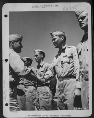 Consolidated > Maj. Gen. Nathan F. Twining, Commanding General of 15th Air Force (left), congratulates 1st Lt. John D. Warnack, Jr., 327 Virginia Ave., McComb, Miss., after giving Warnack the Distinguished Flying Cross for "Extraordinary achievement in aerial