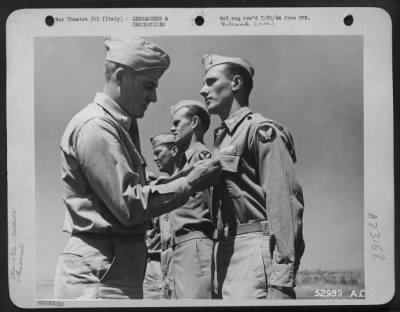 Consolidated > Maj. Gen. Nathan F. Twining, Commanding General of 15th Air Force (left), pins the Distinguished Flying Cross on 1st Lt. William J. Fitzgerald, 253 East 62nd St., New York, N.Y., for "Extraordinary achievement in aerial flight as pilot" of a