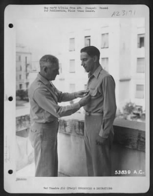Consolidated > Maj. General Nathan F. Twining (left) Commanding General of the 15th Air Force, pins the Air Medal on Lt. Col. Arthur F. Reinhardt, chief of the 15th's Operational Engineering section, for the latter's meritorious work in studying and effecting