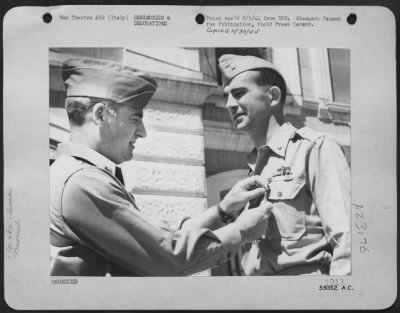 Consolidated > Major General Nathan F. Twining, Commanding General of the 15th AAF in Italy, pins the Distinguished Sevice Medal on Brigadier General Dean M. Strother, Commanding General of a 15th AAF Fighter Wing. General Strother, of Austin, Texas, was cited