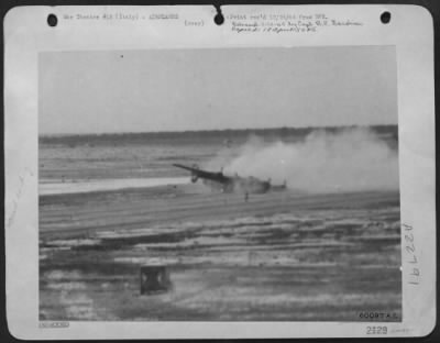 Consolidated > This Picture Of A Consolidated B-24 Liberator Bomber, Taken As It Crash Landed At A 15Th Aaf Base In Italy, Was Snapped By Sgt. Joseph Leclair Of Lewiston, Mo., Photographer With The Group Photo Lab.  The Figure Shrouded By The Dust Of The Still Moving Pl