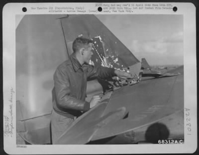Consolidated > 2Nd Lt. G.R. Mcmoody Of Coldwater, Michigan, Pilot With The 79Th Fighter Group Based At Capodichino, Italy, Examines The Damaged Done To His Plane When He Was Jumped By 2 Fw-190S While Patroling The Beachhead.