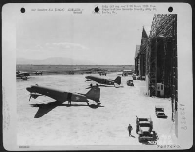 Thumbnail for Consolidated > Douglas C-47S Parked In Front Of Hangars At An Air Base Somewhere In ['Italy' Is Crossed Out And Replaced With 'Casablanca, Morocco'].  90Th Photo Reconn Wing.