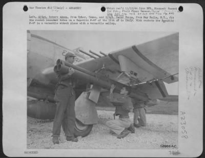 Consolidated > Left, S/Sgt Robert Adams, From Tyler, Texas, And S/Sgt. Oscar Forge, From May Falls, Ny, Fit The Rocket Launcher Tubes On A Republic P-47 Thunderbolt Of The 12Th Af In Italy.  With Rockets The Republic P-47 Thunderbolt Is A Versatile Attack Plane With A V