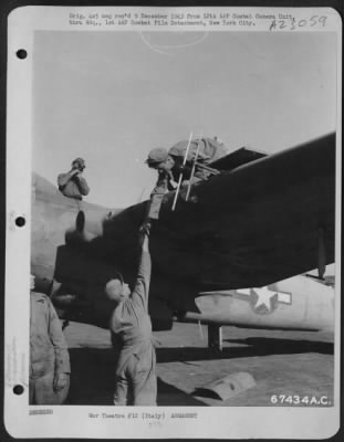 Thumbnail for Consolidated > Armorers Load .50 Cal Ammunition Into Wing Guns Of A Bristol Beaufighter At An Air Base Near Grottaglie, Italy.  17 Nov. 1943.