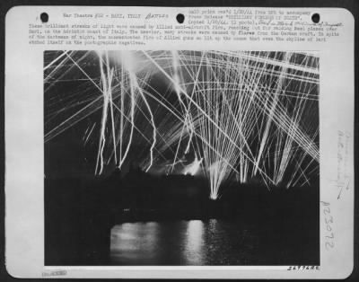 Consolidated > These Brilliant Streaks Of Light Were Caused By Allied Anti-Aircraft Fire, Reaching Out For Raiding Nazi Planes Over Bari, On The Adriatic Coast Of Italy.  The Heavier, Wavy Streaks Were Caused By Flares From The German Craft.  In Spite Of The Darkness Of