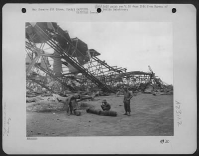 Thumbnail for Consolidated > Air Force Personnel Inspect Enemy Bombs Which Were Captured At Ciampino Airfield Near Rome, Italy.  Hangar In The Background Was Demolished During Bombing Raids By The Mediterranean Army Air Force.