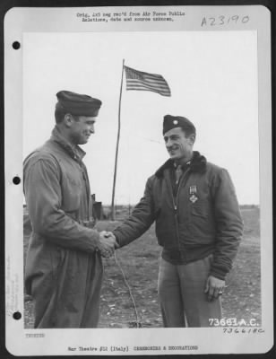 Consolidated > Lt. Colonel William P. Litton, Shaw, Miss., Of The 82Nd Fighter Group, Is Congratulated By Major Lawrence H. Bell, Phoenix, Ariz., After He Was Presented The Distinguished Flying Cross At An Air Base In Italy.